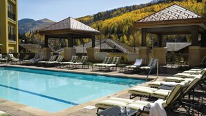 A pool area with lounge chairs and gazebos, surrounded by mountains and trees. - Ritz Carlton Club, San Fransico - 1 Bedroom (San Francisco)