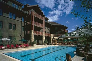Relax by the large pool surrounded by comfortable lounge chairs and umbrellas.