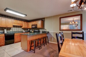Enjoy cooking and dining in this well-equipped kitchen with a central island and dining area.
