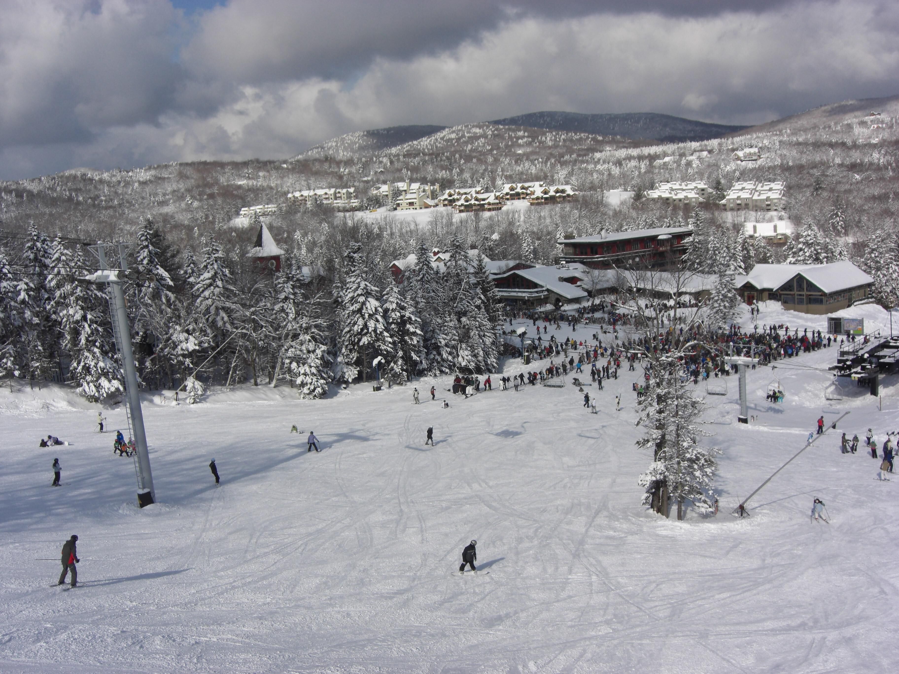 A ski resort with multiple buildings, including a lodge and a ski lift area.