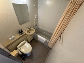 A bathroom with a toilet, sink, and bathtub.