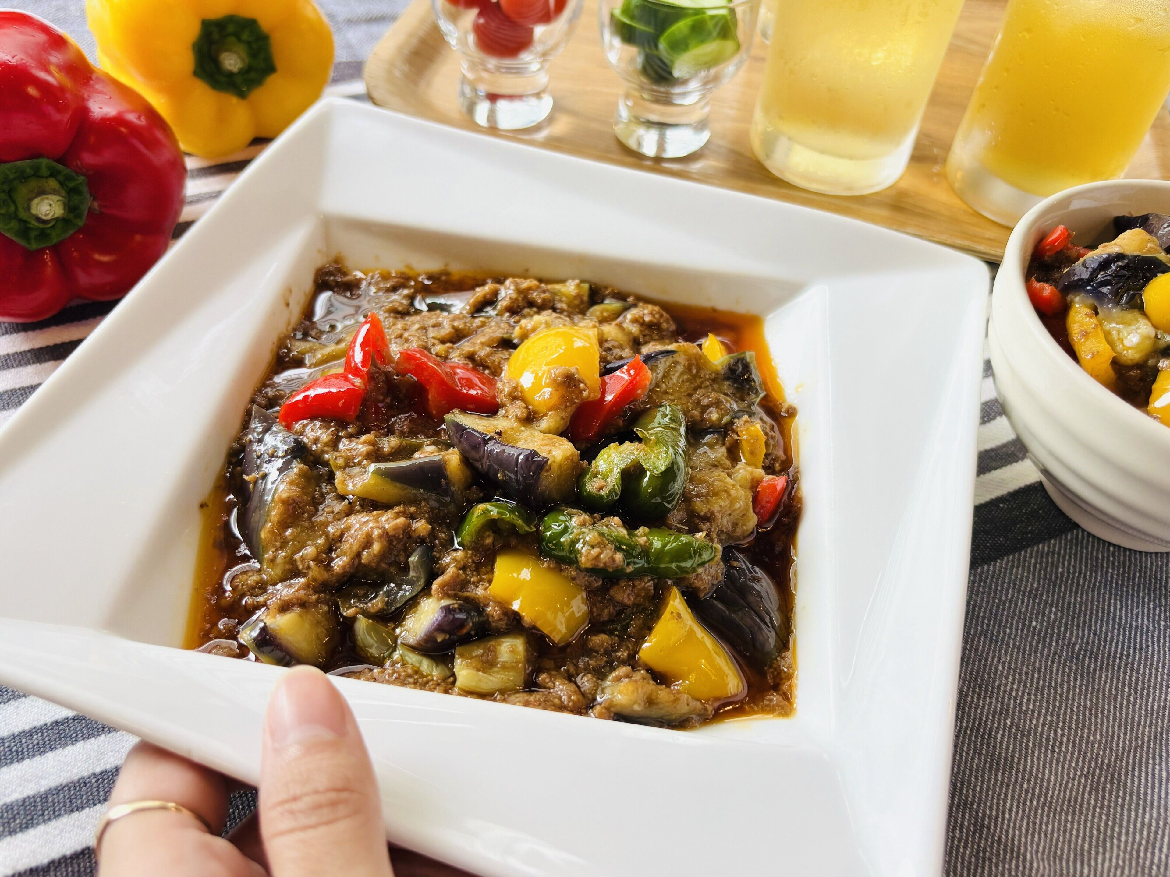 A dish with ground meat, vegetables, and a sauce.