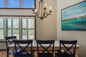 A dining area with a table, chairs, a chandelier, and a painting on the wall. - NEW Private 3 acre waterfront property directly on the Bay! WEEKLY DISCOUNT 10% (Sturgeon Bay)