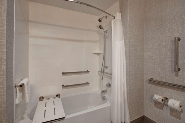 A modern bathroom with a bathtub, shower, and toilet. - Hampton Inn And Suites Deptford (Woodbury)
