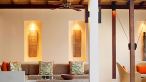 A cozy living room with a sofa, a coffee table, and a wicker chair. - Elegant Cliffside Villa with Breathtaking Views – Bali Villa 1031 (Bali)