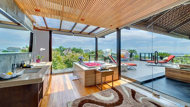 A modern kitchen with a wooden ceiling, large windows, and a view of the city. - Bali Villa 1029: Where Luxury Meets the Sky (Bali)