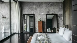 A modern bedroom with a large bed, a mirror, and a view of the outdoors. - Luxury Villa Escape with Exceptional Staff – 1028 (Bali)