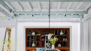A modern kitchen with a central island, wooden cabinets, and green stools. - Bali Villa 1010: Ultimate Luxury Retreat with Private Pool (Bali)