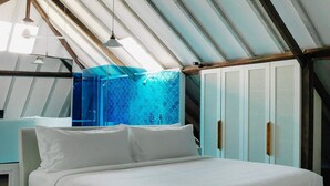 A bedroom with a bed, wooden floor, and a sloped ceiling with exposed beams. - Bali Villa 1010: Ultimate Luxury Retreat with Private Pool (Bali)