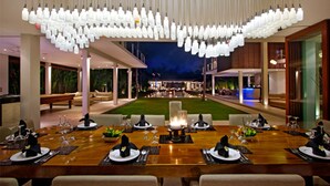 A dining area with a long wooden table set for a meal, surrounded by chairs. - Exclusive Luxury Villa with Pool & Entertainment – Bali Villa 1059 (Bali)
