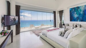 A modern bedroom with a large bed, a TV, and a view of the ocean. - Cliffside Retreat with Pool & Ocean Views – Bali Villa 1065 (Bali)