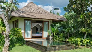 A thatched-roof bungalow with a glass-enclosed bedroom and a small pool. - Elegant Estate with Private Pool - Bali Villa 1007 (Bali)
