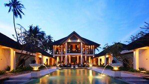 A large, two-story hotel with a central pool and a symmetrical design. - Seaside Serenity with Private Pool – Bali Villa 1016 (Bali)