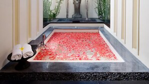 A modern bathroom with a skylight, a stone basin, and decorative plants. - Seaside Serenity with Private Pool – Bali Villa 1016 (Bali)