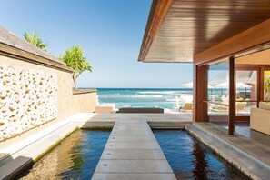 A pool area with a view of the ocean, a palm tree, and outdoor seating. - Private Beachfront Escape – Bali Villa 1115 (Bali)