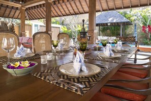 A dining table set for a meal with a tropical garden view. - Serene luxury in lush gardens, Bali Villa 1124 (Bali)