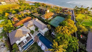 An aerial view of a residential area with houses, a tennis court, and a swimming pool. - Tropical Breeze Ocean Views - Bali Villa 1128 (Bali)