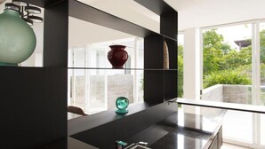 A modern bathroom with a large mirror, a black countertop, and a view of greenery outside. - Modern Beachside Escape with Private Pool – Bali Villa 1108 (Bali)
