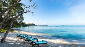 A beach with lounge chairs and a clear view of the ocean. - This Perfect 5 Star Villa in Koh Samui with Beachside Private Pool, Villa Waimarie 1005 (Koh Samui)