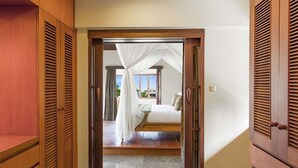A hotel room with a bed, a window, and a view of the sea.