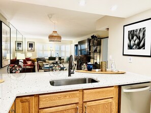Enjoy cooking in this well-lit kitchen with a large island and wooden cabinetry.