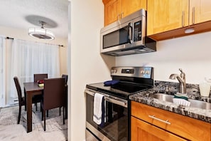 Enjoy meals at the dining table with oven and microwave.