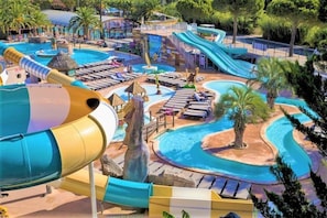A water park with multiple slides, pools, and lounge areas.