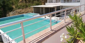 Enjoy a refreshing swim in our rooftop pool surrounded by lush greenery and a beautiful garden.