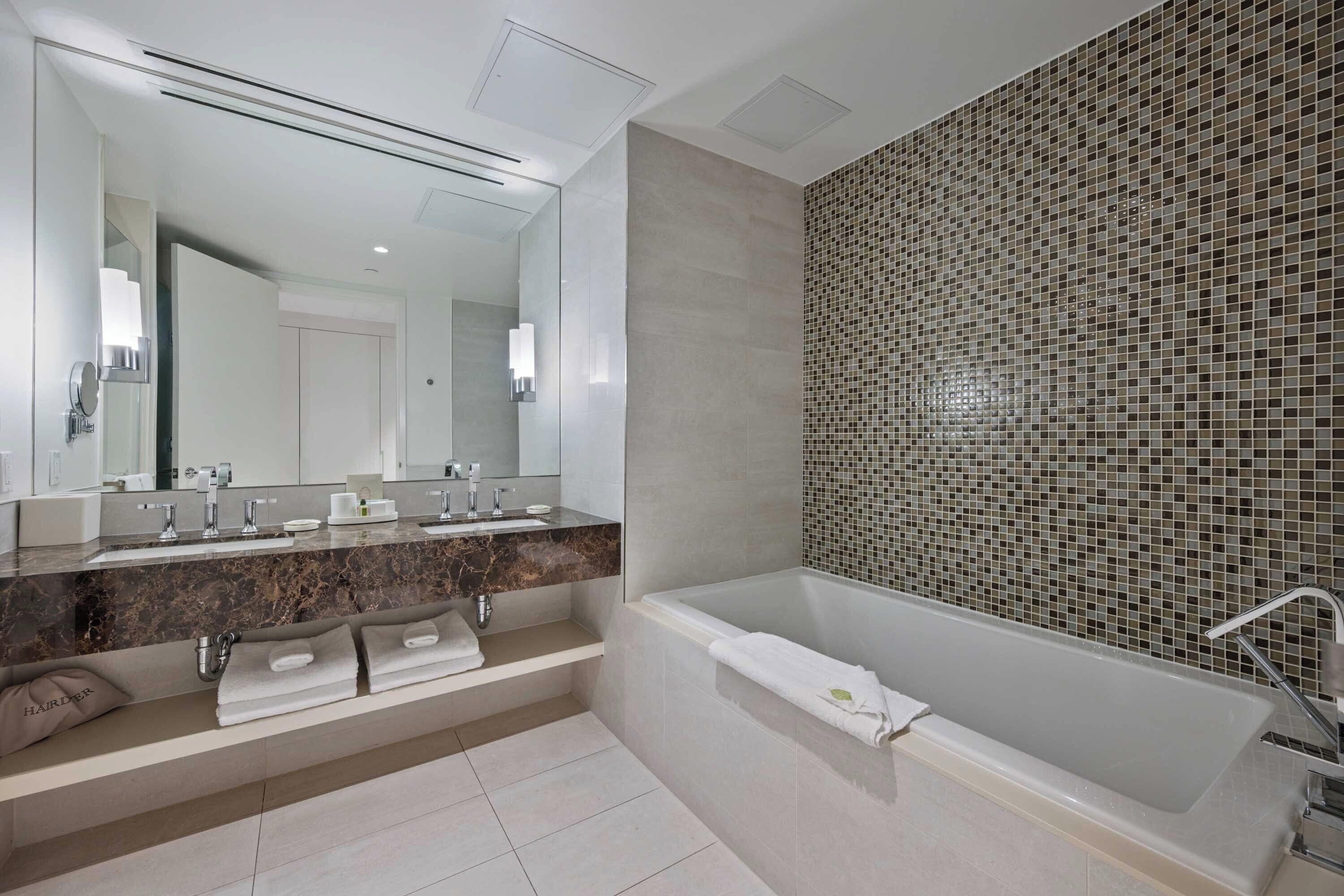 deluxe room, 1 king bed | bathroom | designer toiletries, hair dryer, bathrobes, slippers