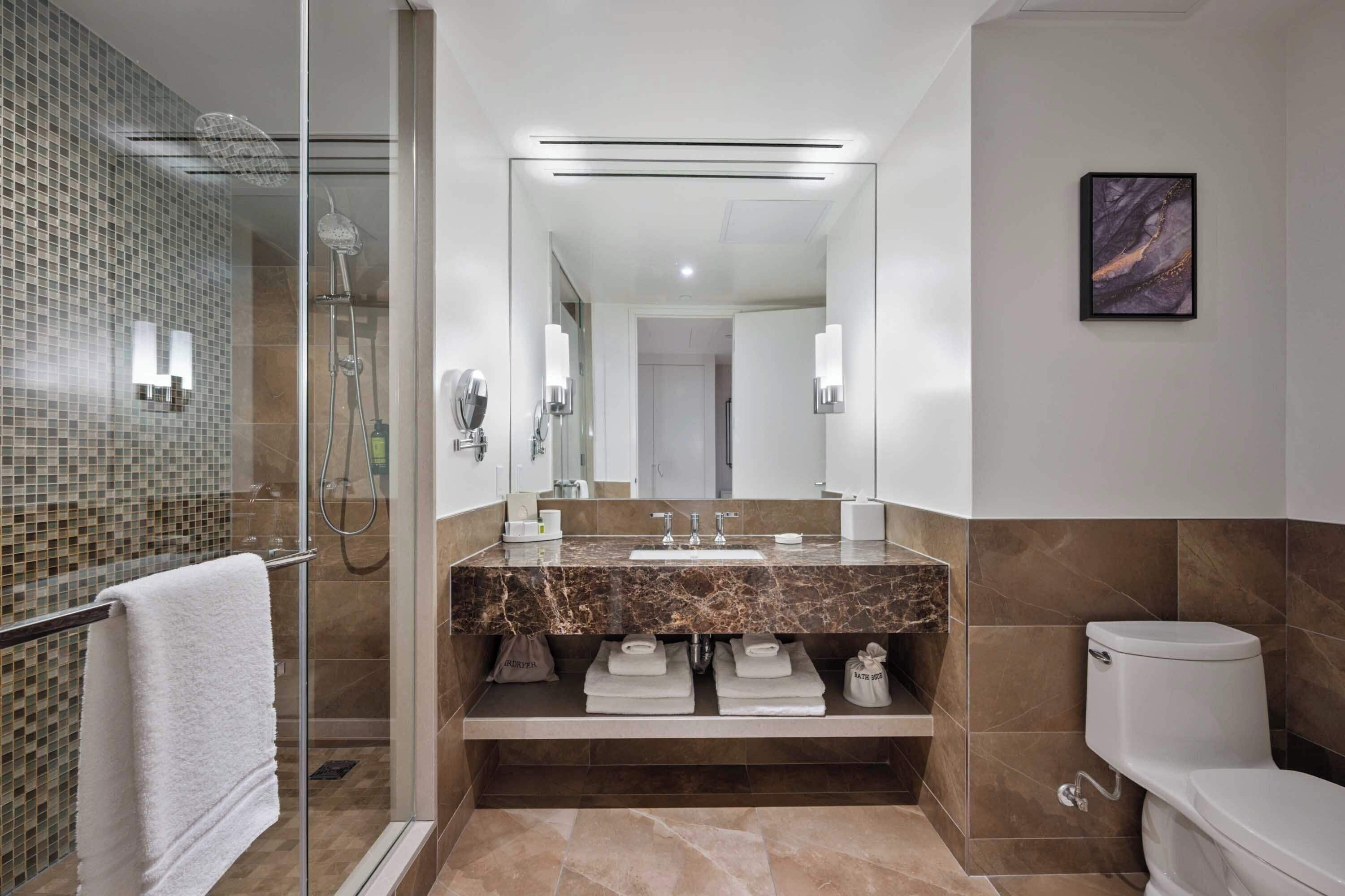 designer toiletries, hair dryer, bathrobes, slippers