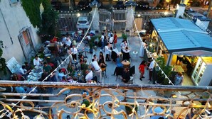An outdoor dining area with tables and chairs, surrounded by a decorative metal fence. - Lappart Hôtel SKA (Saint Rémy de Provence)
