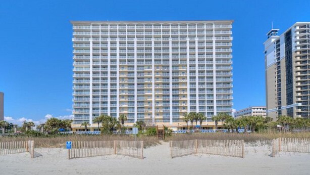 A large, multi-story hotel with a uniform facade and balconies.