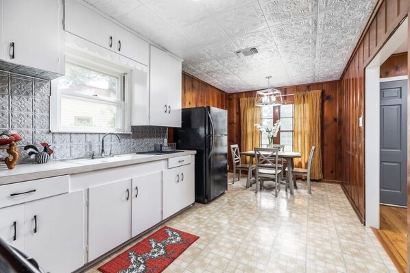 Microwave, coffee/tea maker, cookware/dishes/utensils, dining tables