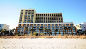 Ein mehrstöckiges Hotel mit flachem Dach und vielen Fenstern.