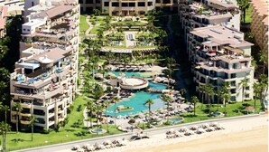 A resort with multiple buildings, a central pool area, and a beach. - Located on the pristine Medano beach (Cabo San Lucas)