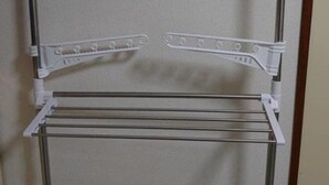A white drying rack with multiple shelves and hangers, mounted on a wall. - Hokusei Building 41 (Sapporo)