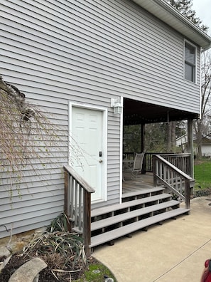 A residential house with a front porch, a door, and a small deck. - Quiet 1/1 in Historic Village of Milan, OH just minutes away from Cedar Point (Milan)