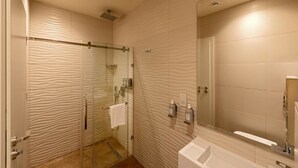 A modern bathroom with a glass shower enclosure, a large mirror, and a white sink. - City Palace Hotel (Cairo)
