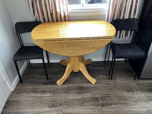 Enjoy meals in this dining area with a round table and two comfortable chairs.