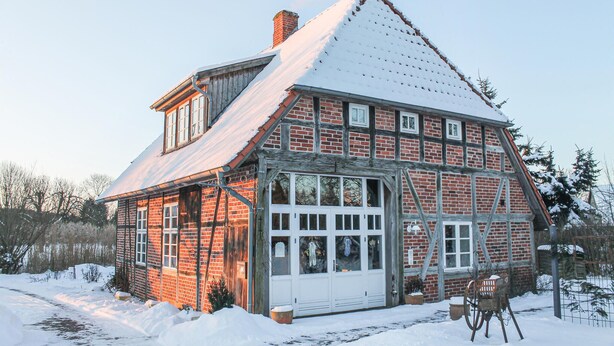 A traditional half-timbered house with a steep gabled roof, large windows, and a wooden door. - 3 bedroom beautiful home in Thandorf (Thandorf)