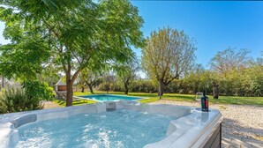 A hot tub surrounded by trees and a swimming pool in a backyard. - Gorgeous home in Prkos (Prkos)
