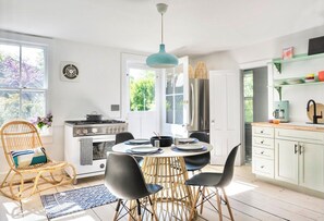 Enjoy cooking in this well-equipped kitchen with a central island, dining table, and comfortable seating area.