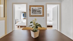 A dining area with a wooden table, a potted plant, and a framed picture on the wall. - Bellavista 4 by Interhome (Parpan)