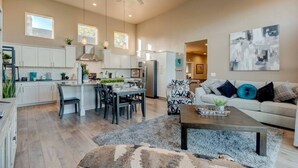 A spacious living area with a kitchen, dining table, and a sofa set. - Sleeps 12~Great View! UNR~Deck~Reno~Minerva House~ Near Downtown~Family Fun (Reno)