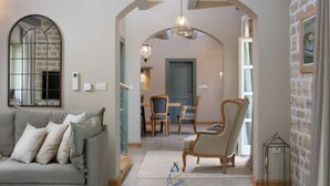 A cozy living room with a sofa, two chairs, a decorative mirror, and a hanging light fixture. - Luxury country villa for 10 with pool, and playgrounds (Kanfanar)