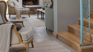 A cozy living room with a stone fireplace, comfortable seating, and a staircase. - Luxury country villa for 10 with pool, and playgrounds (Kanfanar)