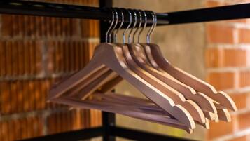 A metal rack with multiple wooden hangers.
