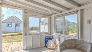 A room with a view of a house and a dock. - Bungalow 2 - 1br, Water View (Westhampton Beach)