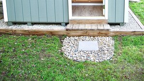 A small shed with a kitchen area, including wooden cabinets and a sink. - Secluded in the woods. No neighbors in sight. (Pullman)