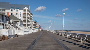 A boardwalk with benches, a promenade, and buildings with balconies. - Perfect Family Beach Stay • Private Courtyard • Walk Everywhere (Ocean City)